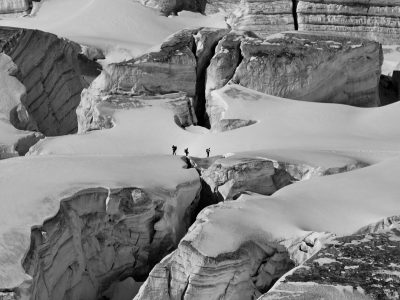 Three climbers navigating the icy crevasses of Chamonix-Mont-Blanc, France.
